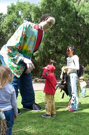 A KneeHIGH Puppet spins Michael's propeller while Theen looks on